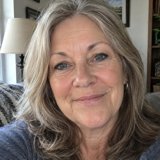 Linda, a smiling woman with gray-blonde hair